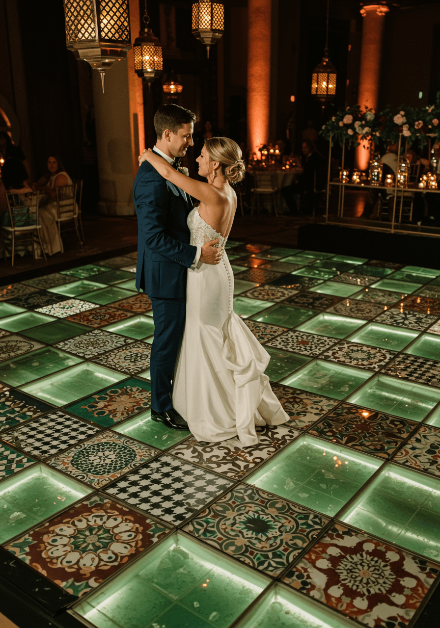 Close-up of dancing couple on patterned floor with uplighting effects